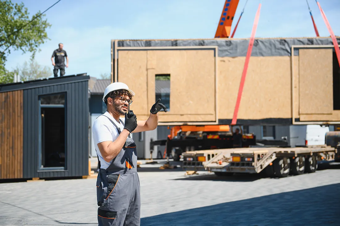 construction-worker-directing-modular-house-placem-2025-08-27-08-25-59-utc