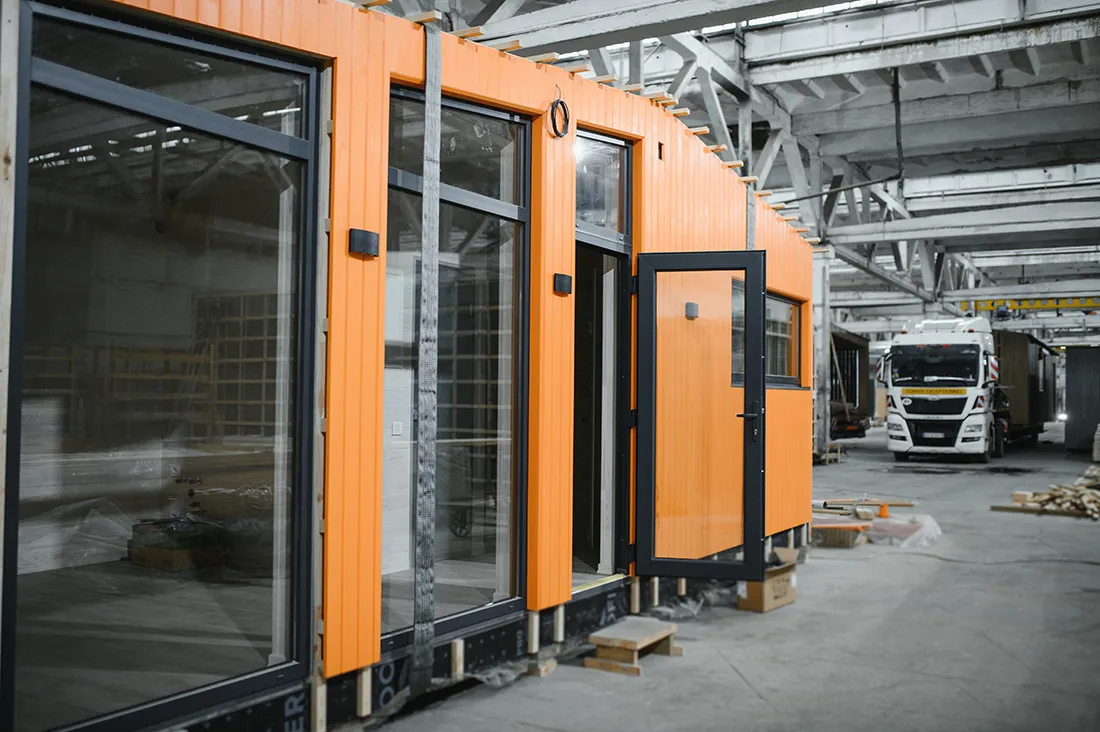 construction-workers-building-modular-orange-house-2025-06-08-19-59-17-utc